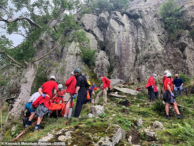 More than two dozen mountain rescue personnel rushed to the scene and pictures show the man being treated on the mountainside