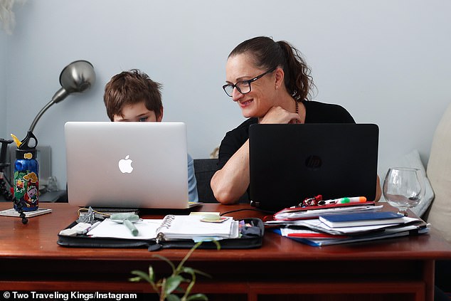 The economists said school and childcare closures only worsened productivity levels. Pictured Donna Eddy helps her son Phoenix with school work during lockdown in Sydney