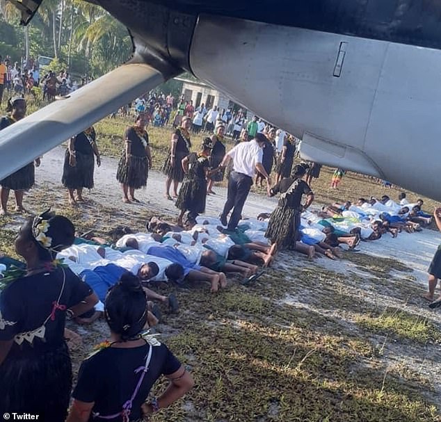 The grainy photograph that appeared on social media showed a man in a white shirt and grey trousers stepping on the backs of about 30 people lined up on the ground. The man in question is reported to be Tang Songgen, the Chinese ambassador to the Pacific island nation of Kiribati