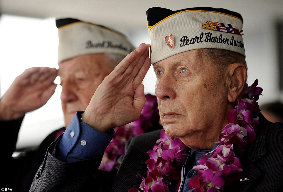 Veteran: Pearl Harbor survivor Aaron Chabin, right, salutes while listening to the National Anthem during a ceremony on the USS Intrepid Sea, Air, and Space Museum in New York to commemorate the attacks on Wednesday