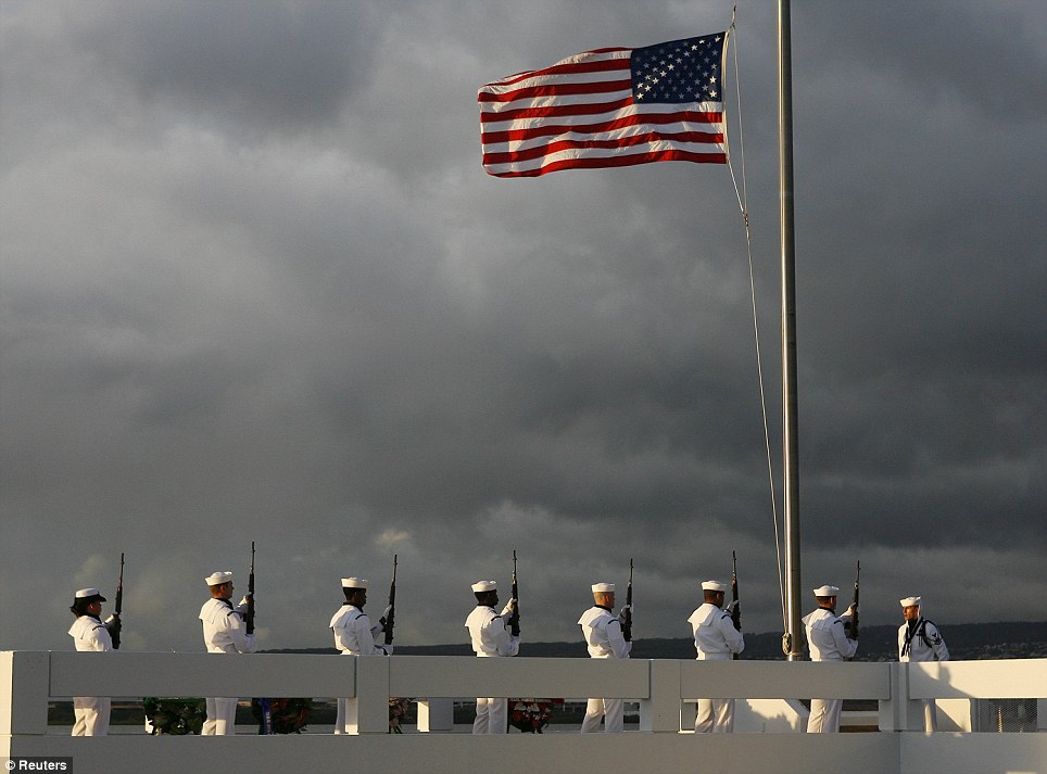 Honouring: U.S. Navy sailors give a 21-gun salute to Pearl Harbor survivor Lou Soucy, whose remains were being interned on the USS Utah, during a memorial ceremony on Ford Island in Honolulu, Hawaii, on Tuesday
