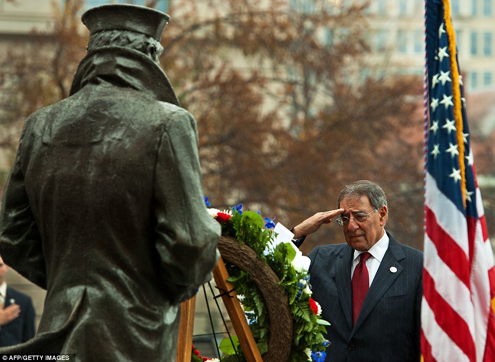 Emotional: U.S. Secretary of Defense Leon Panetta salutes in the rain after a commemorative wreath was placed at the US Navy Memorial statue in Washington D.C. on Wednesday
