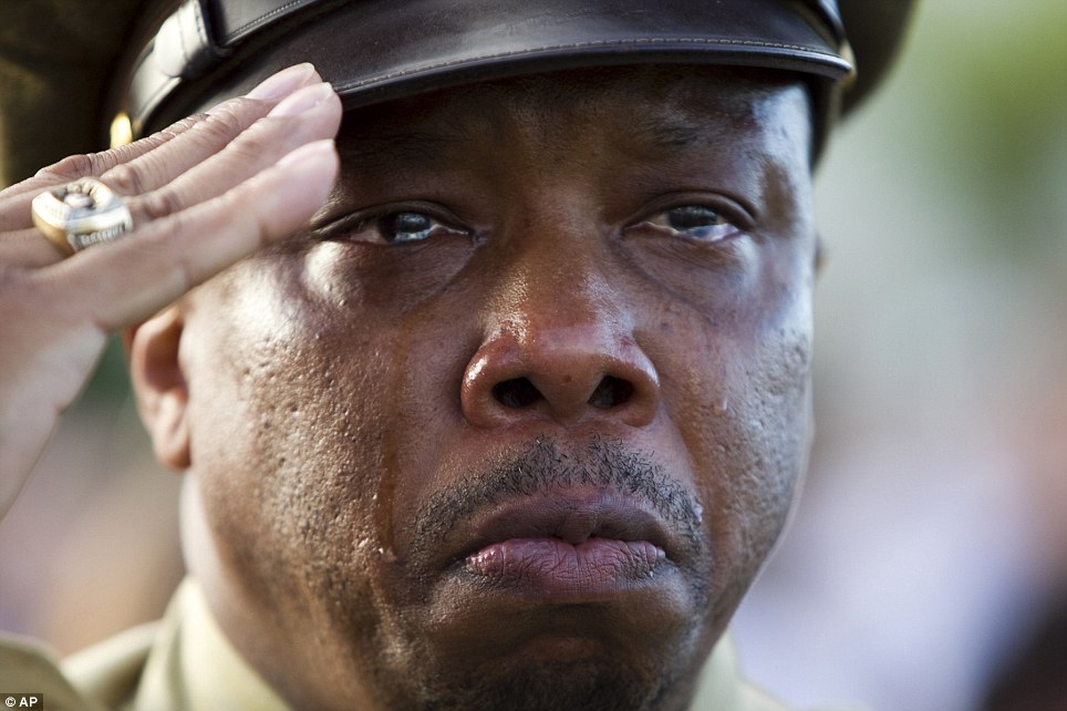 Tears: National Parks Service Historian John McCaskill, of Washington D.C., reacts to the national anthem during the Pearl Harbor memorial ceremony on Wednesday