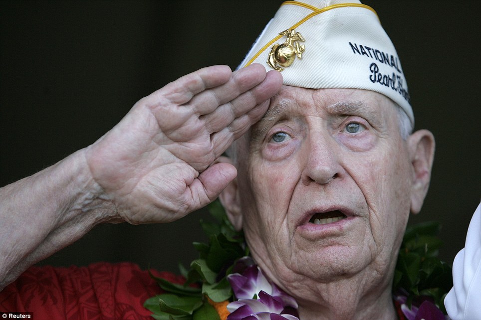 Proud: Pearl Harbor survivor Mal Middlesworth sings the national anthem as he salutes the Color Guard during the 70th anniversary of the attack on Pearl Harbor in Hawaii on Wednesday