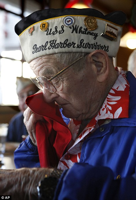 Bob Hodenson, a member of the Sacramento Chapter of the Pearl Harbor Survivors Association wipes a tear during a ceremony to honor the 70th anniversary of the Japanese attack on Pearl Harbor, held in Sacramento, Calif