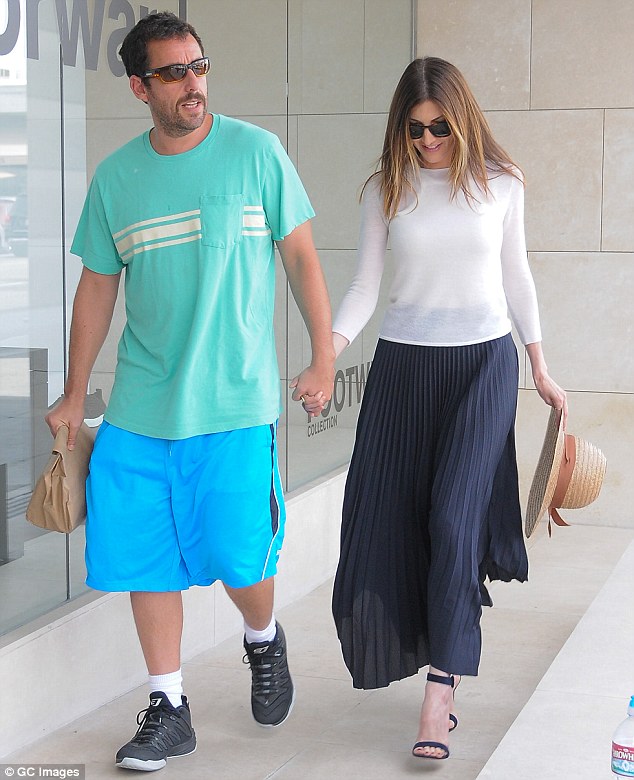 Going strong: Adam Sandler, 49, and his wife Jackie, 41, looked like a new couple in love as they were spotted holding hands in Los Angeles on Tuesday