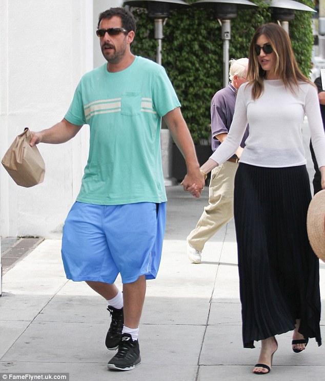 Opposites attract: Unlike Adam, his gorgeous spouse looked fashionably put together for their romantic outing. Jackie showed off her lean figure in a white top and a long pleated navy skirt and wore heels