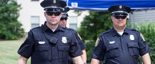 Police officers walking along the street.