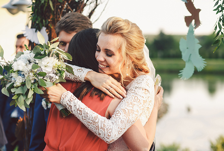 Bride hugging friend